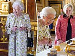 Queen uses a walking stick as she views hand-decorated luxury pieces