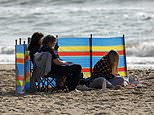 Beachgoers enjoy 20C mini-heatwave before chills return next week 