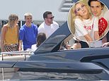 David Beckham wraps his arm around son Romeo, 19, as they relax on £5million yacht in Miami