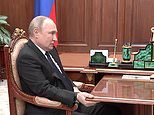 Putin is seen gripping a table amid cancer battle rumours as he meets ‘slurring’ defence minister