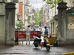 Shanghai officials put up FENCES outside residential buildings in zero-Covid lockdown