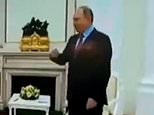 Putin’s hand shakes before he grips chair arm and awkwardly taps feet in latest sign of ill health