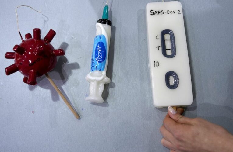 COVID-themed candles on sale in Greece for Orthodox Easter