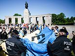 Germany CONFISCATES Ukrainian flag as protesters unveil it at Soviet World War Two memorial